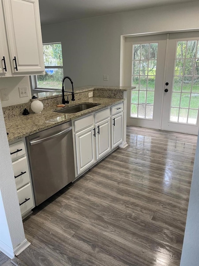 kitchen featuring light stone countertops, white cabinetry, sink, dark hardwood / wood-style flooring, and stainless steel dishwasher