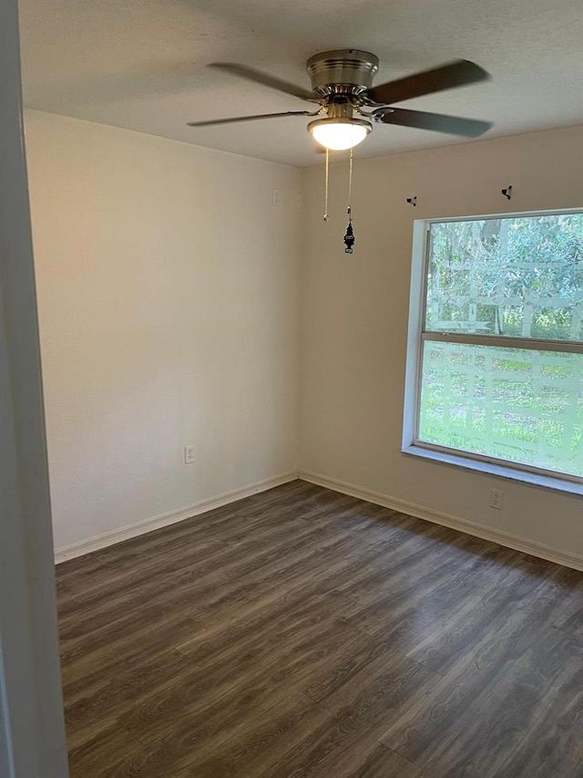 unfurnished room with ceiling fan and dark hardwood / wood-style floors