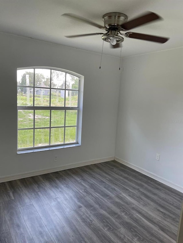 spare room with plenty of natural light, dark wood-type flooring, and ceiling fan