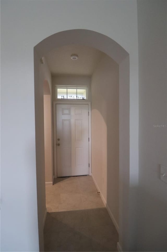 hall featuring light tile flooring