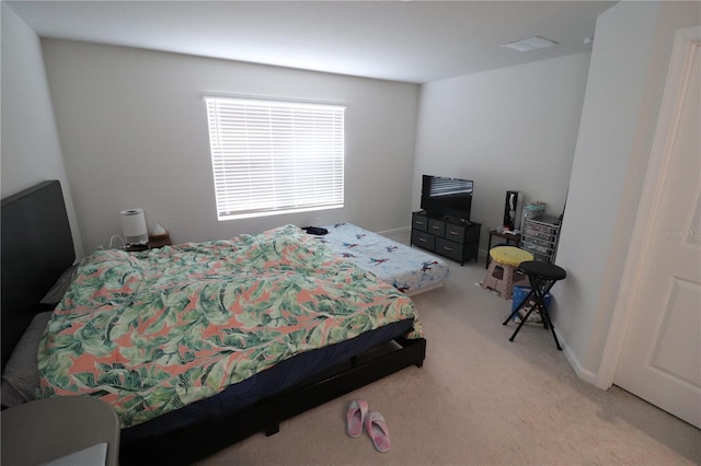 bedroom featuring light colored carpet