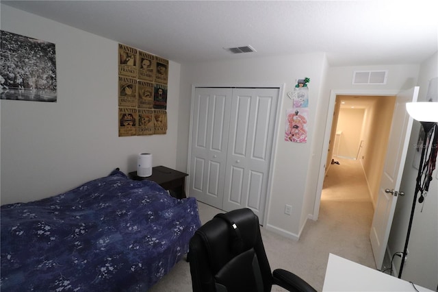 bedroom with light colored carpet and a closet