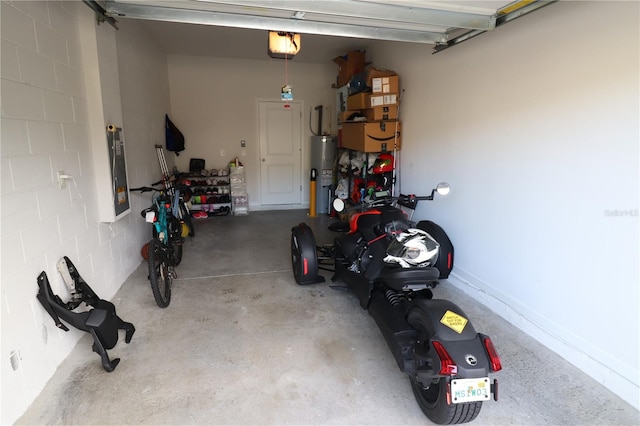 garage featuring electric water heater and a garage door opener