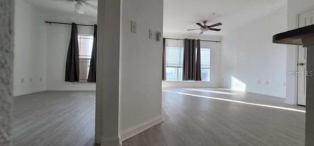 spare room with dark hardwood / wood-style floors and ceiling fan