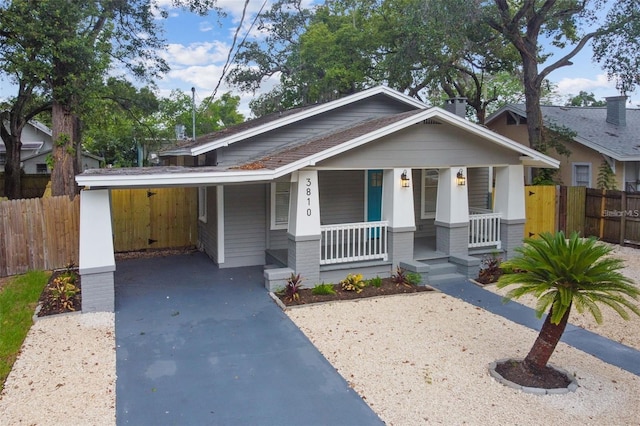 view of front facade with a porch and a carport