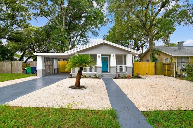 view of front facade featuring a porch and a carport