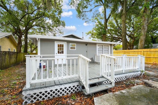 rear view of property featuring a deck