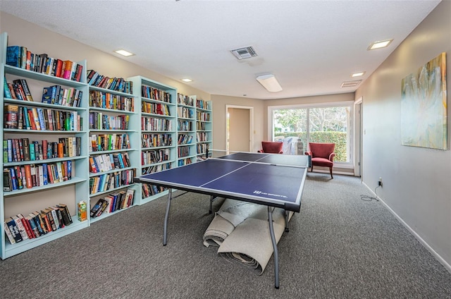 playroom with a textured ceiling and carpet floors