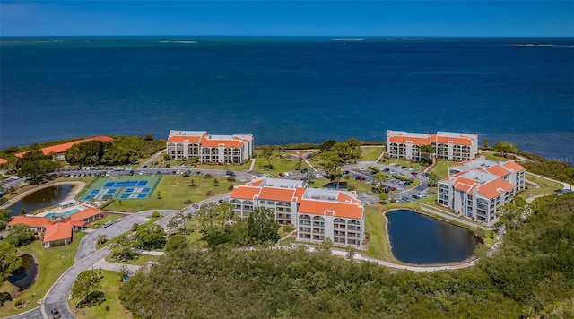 birds eye view of property with a water view