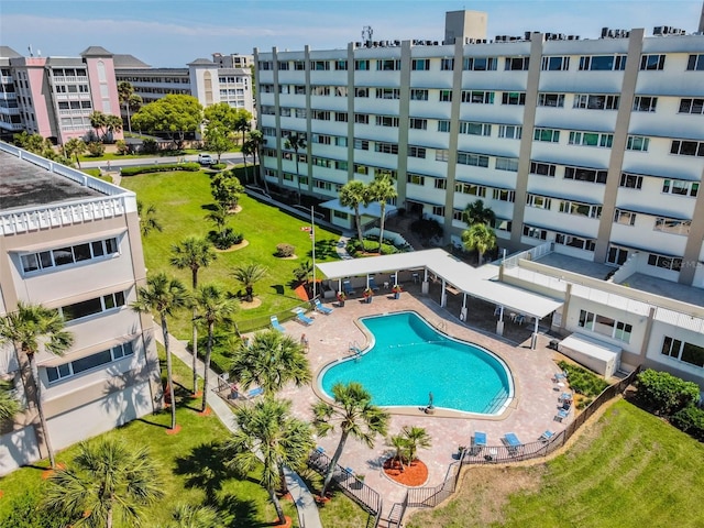 view of pool with a patio and a yard