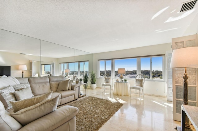 tiled living room featuring a textured ceiling