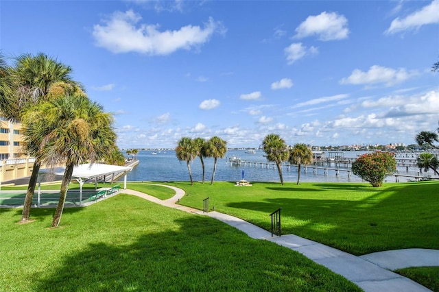 view of home's community with a yard and a water view