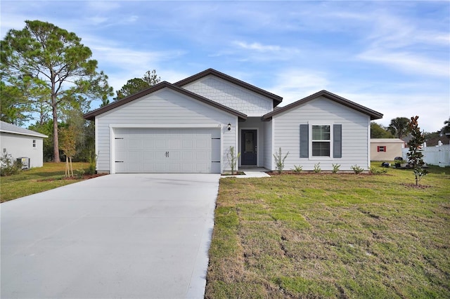 ranch-style house featuring a front lawn and a garage