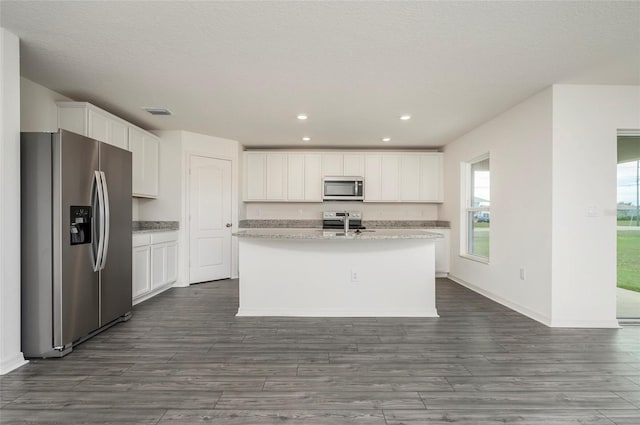 kitchen with white cabinetry, a kitchen island with sink, stainless steel appliances, and dark hardwood / wood-style flooring