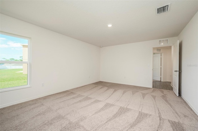 unfurnished room featuring light carpet