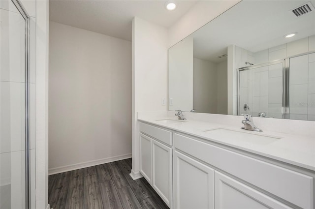 bathroom with vanity, hardwood / wood-style floors, and an enclosed shower