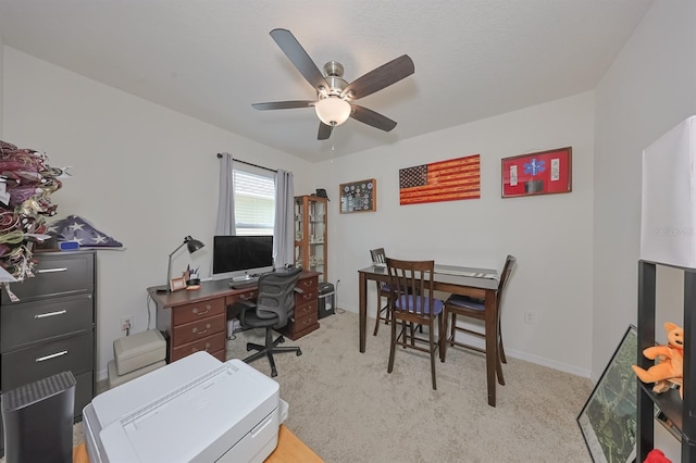 carpeted office featuring ceiling fan