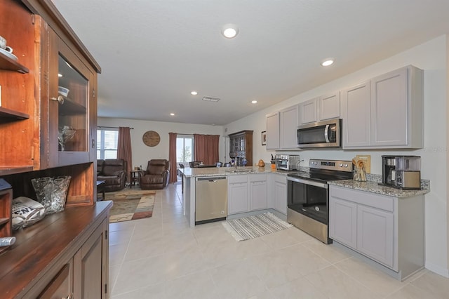 kitchen featuring appliances with stainless steel finishes, light tile patterned flooring, and gray cabinets