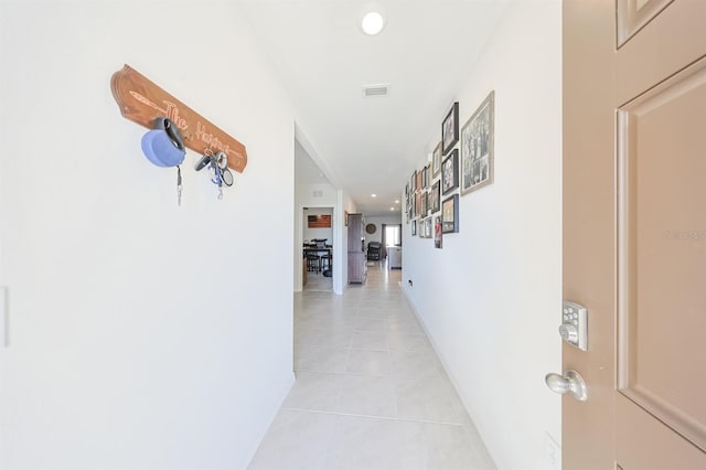 hall featuring light tile patterned floors