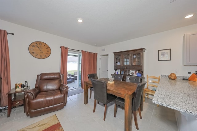 dining space featuring light tile patterned floors