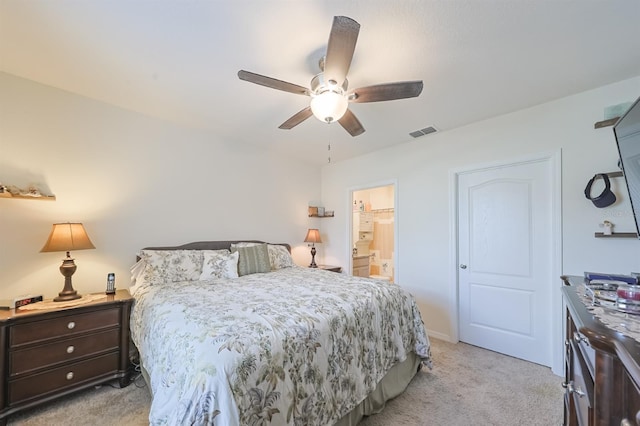 carpeted bedroom featuring ceiling fan and ensuite bathroom