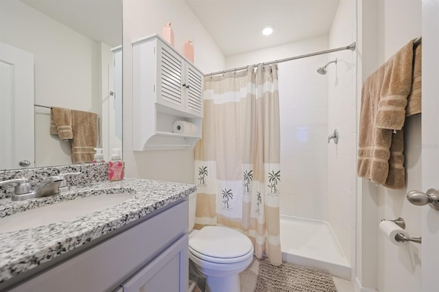 bathroom featuring toilet, vanity, a shower with curtain, and tile patterned floors