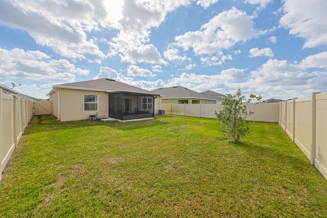 rear view of property with a sunroom and a lawn