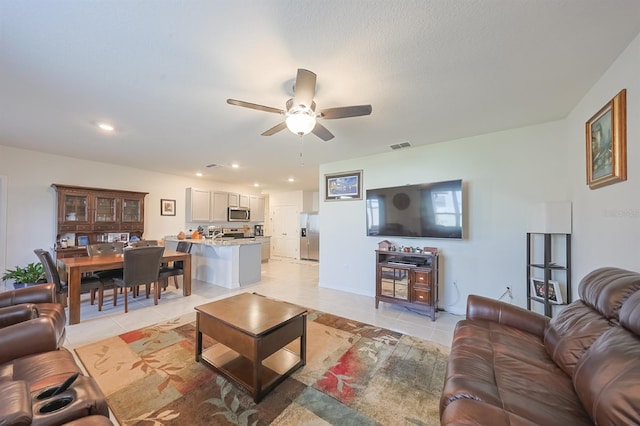 tiled living room featuring ceiling fan