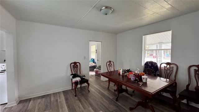 dining area featuring baseboards and wood finished floors