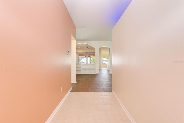 hall featuring light tile flooring