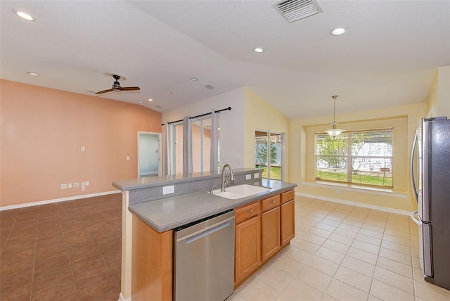 kitchen with light tile floors, ceiling fan, appliances with stainless steel finishes, lofted ceiling, and sink