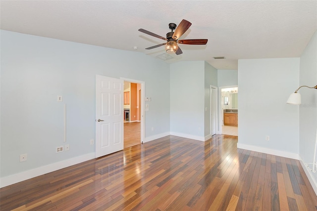 interior space featuring dark hardwood / wood-style floors, vaulted ceiling, and ceiling fan