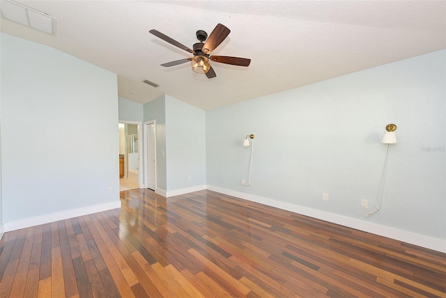 empty room featuring dark hardwood / wood-style floors, ceiling fan, and vaulted ceiling