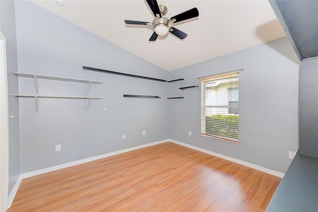 spare room featuring ceiling fan, vaulted ceiling, and light wood-type flooring