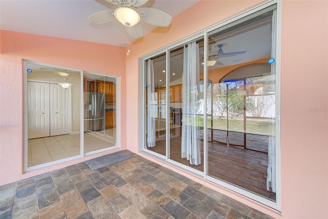 unfurnished sunroom featuring lofted ceiling and ceiling fan