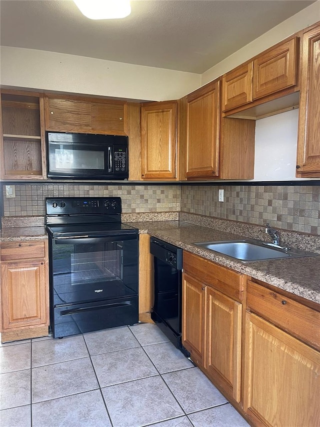 kitchen with tasteful backsplash, light tile floors, black appliances, and sink