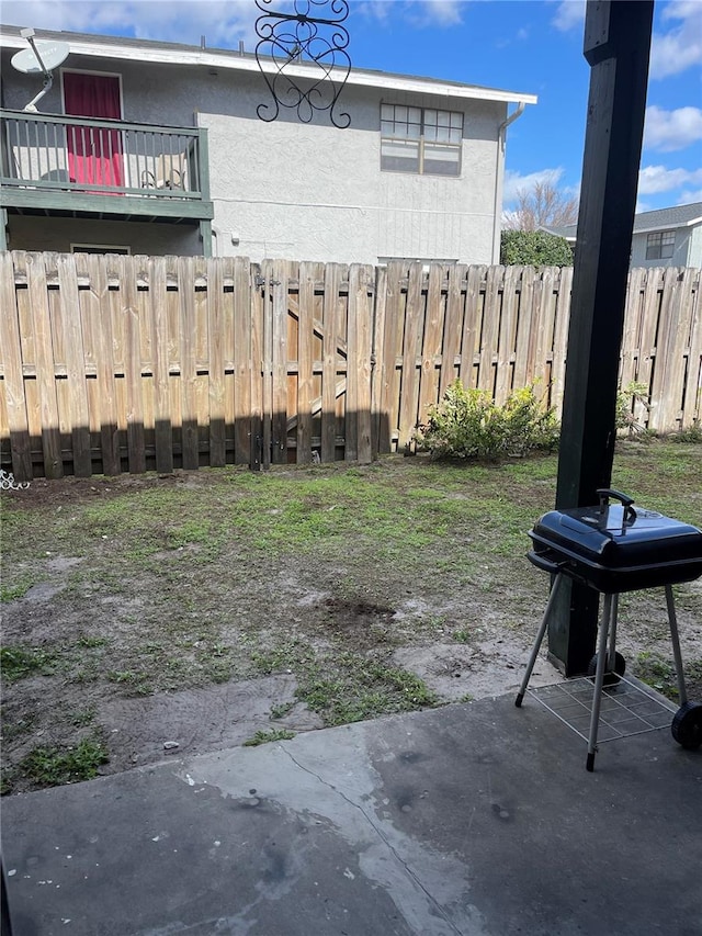 view of yard featuring a balcony and a patio area