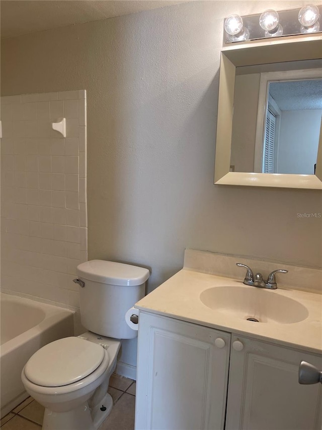 full bathroom featuring tiled shower / bath combo, vanity, tile flooring, and toilet