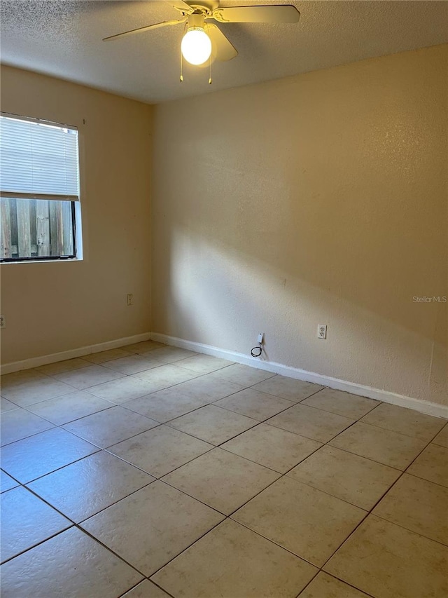 unfurnished room featuring light tile floors, a textured ceiling, and ceiling fan