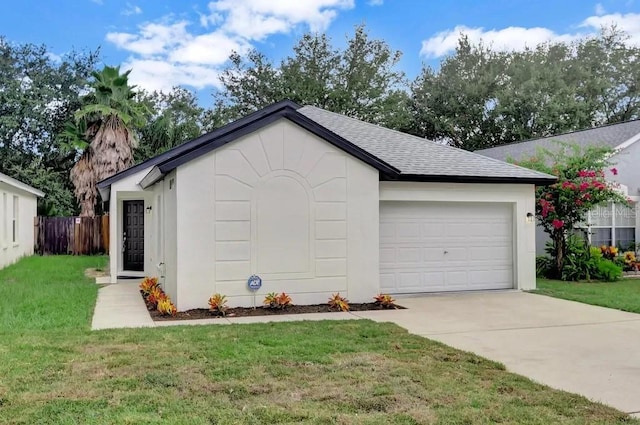 view of front of house featuring a front yard and a garage