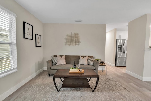 living room with a healthy amount of sunlight and light wood-type flooring