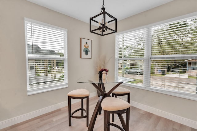 dining room with a chandelier, light hardwood / wood-style floors, and a wealth of natural light