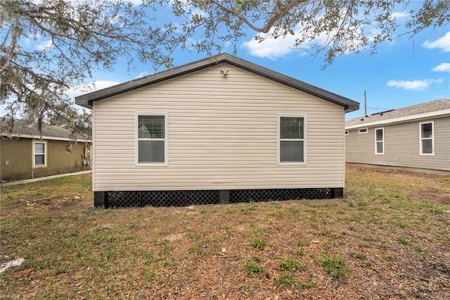 view of side of home with a yard