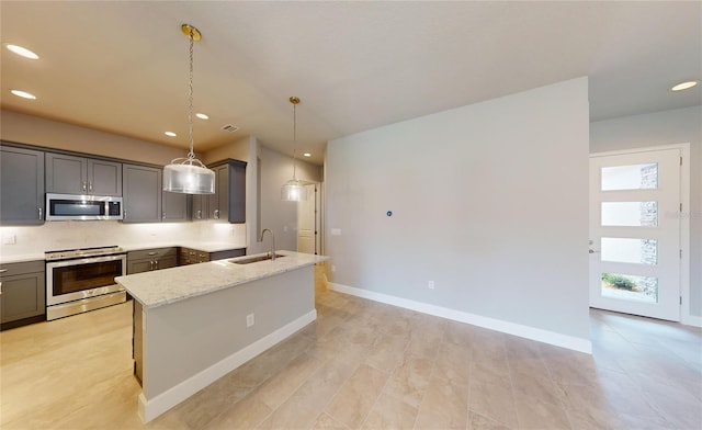 kitchen with appliances with stainless steel finishes, sink, hanging light fixtures, and gray cabinetry