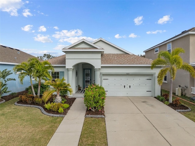 view of front of home featuring a front yard and a garage