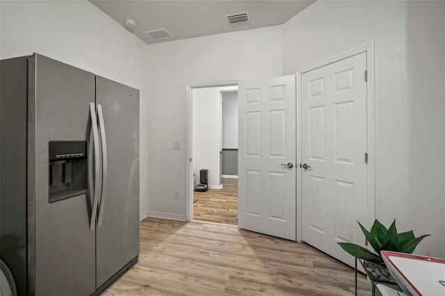 kitchen featuring stainless steel fridge and light wood-type flooring