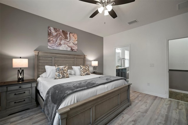 bedroom featuring ensuite bath, ceiling fan, and light hardwood / wood-style flooring