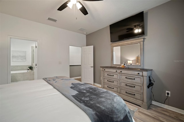 bedroom with light hardwood / wood-style flooring, ensuite bath, and ceiling fan