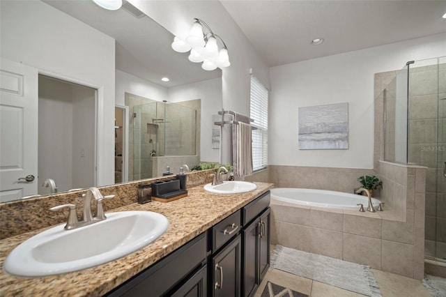 bathroom featuring tile patterned flooring, vanity, and shower with separate bathtub