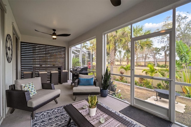 sunroom featuring ceiling fan